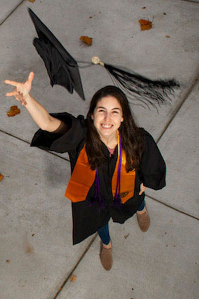 Kim Hertz throwing up her graduation cap. 