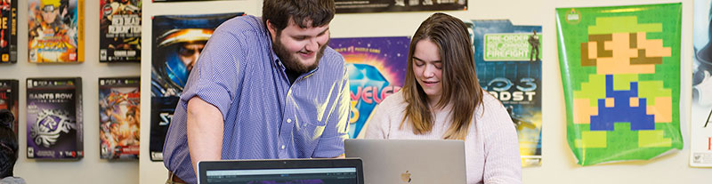 Two students looking at a computer. 