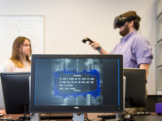 Two students using virtual reality hardware. 