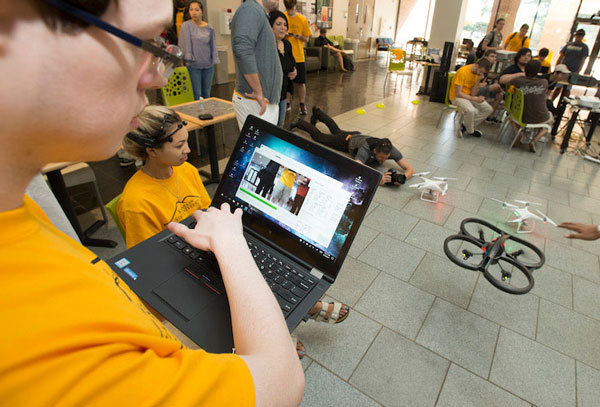 Students testing out a flying drone. 