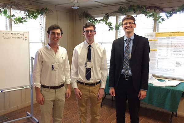 All three students posing together.