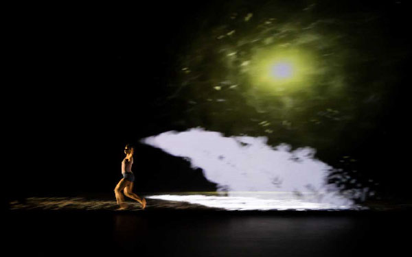 A student dancing across the stage, with moon dust trailing behind them.