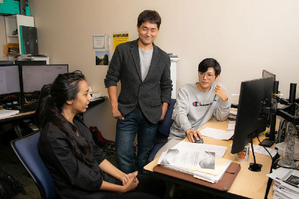 KSU CCSE associate professor Donghyun (David) Kim, center, talks with Jhilakshi Sharma, left, and Hong Kyu Lee 