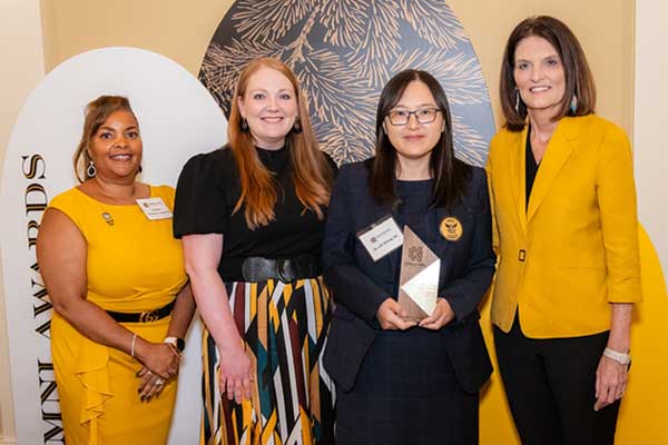 Lilli Zhang along with KSU president, Kathy Schwaig and others presenting award.