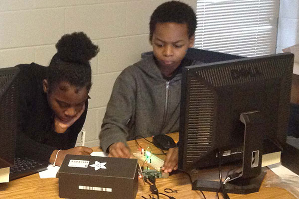 Middle school students working with a Raspberry Pi