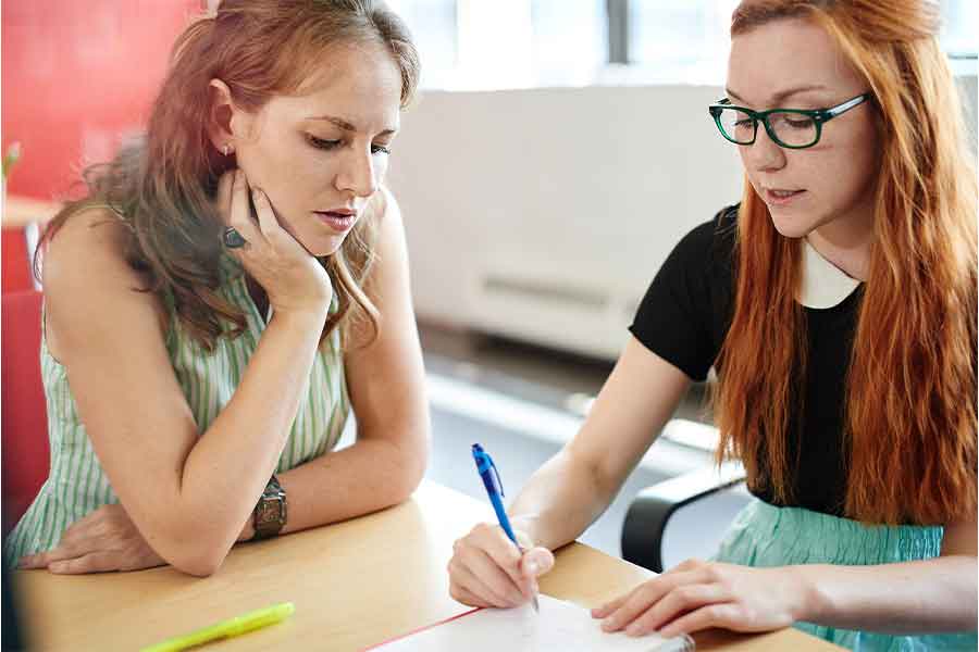 KSU Graduate students looking at financial assistance programs.