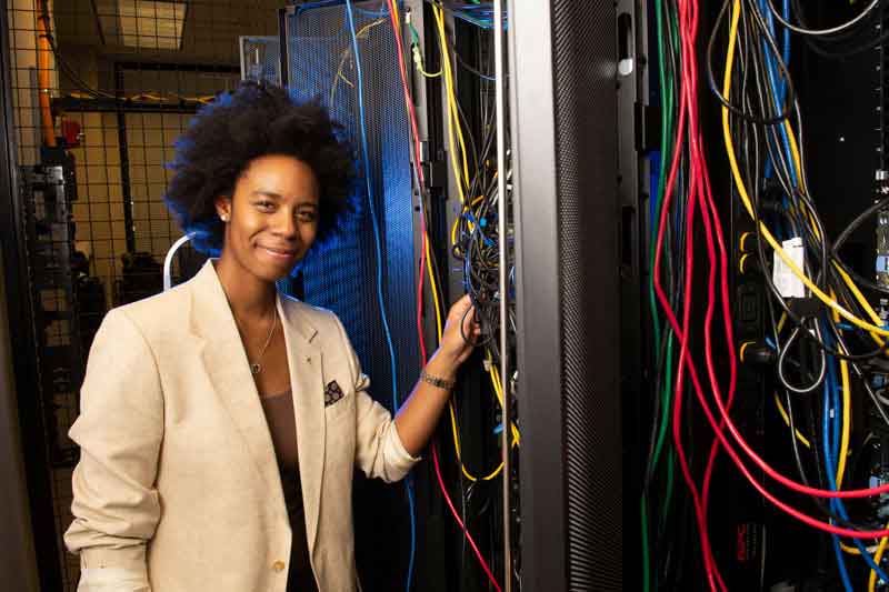 A student posing with network computer wires. 