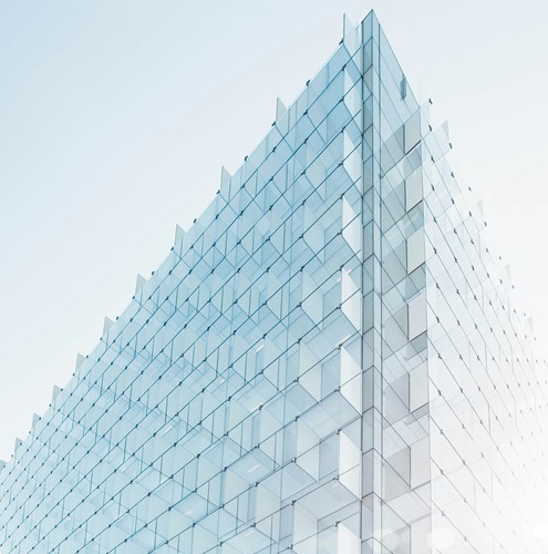 glass building with an architectural structure that looks like each window is a block and scaffolded for a secure structure.