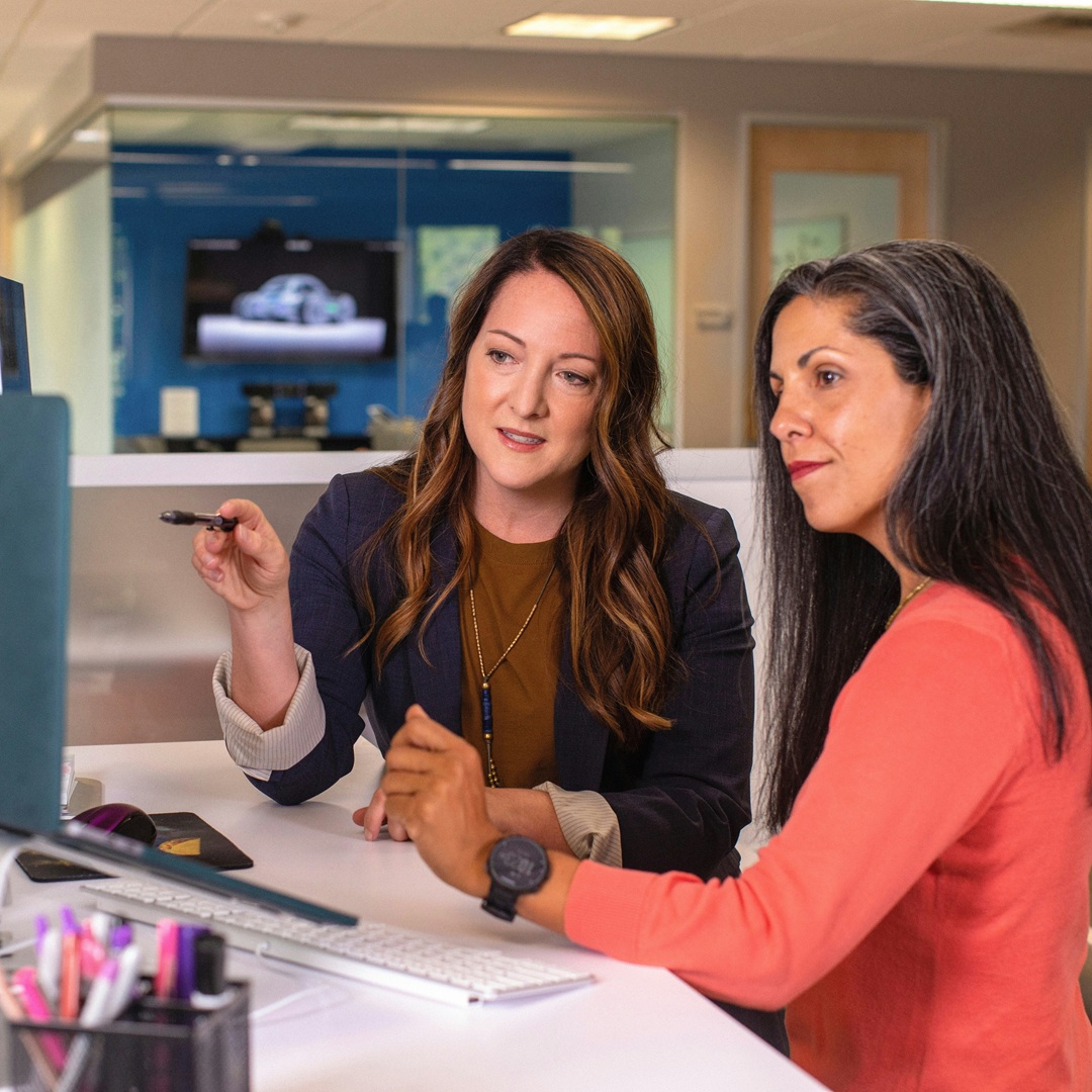 two office workers working one on one on the computer