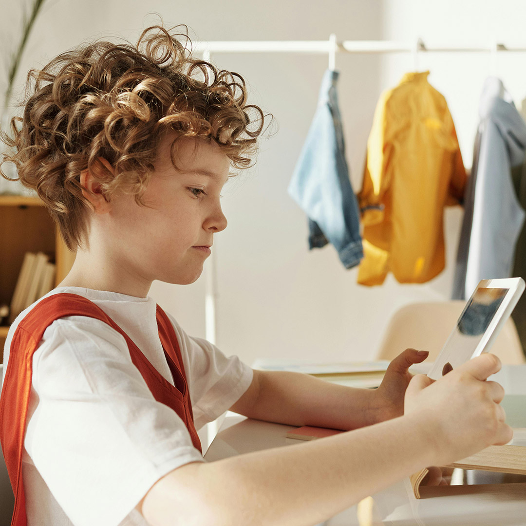 little kid doing homework on tablet