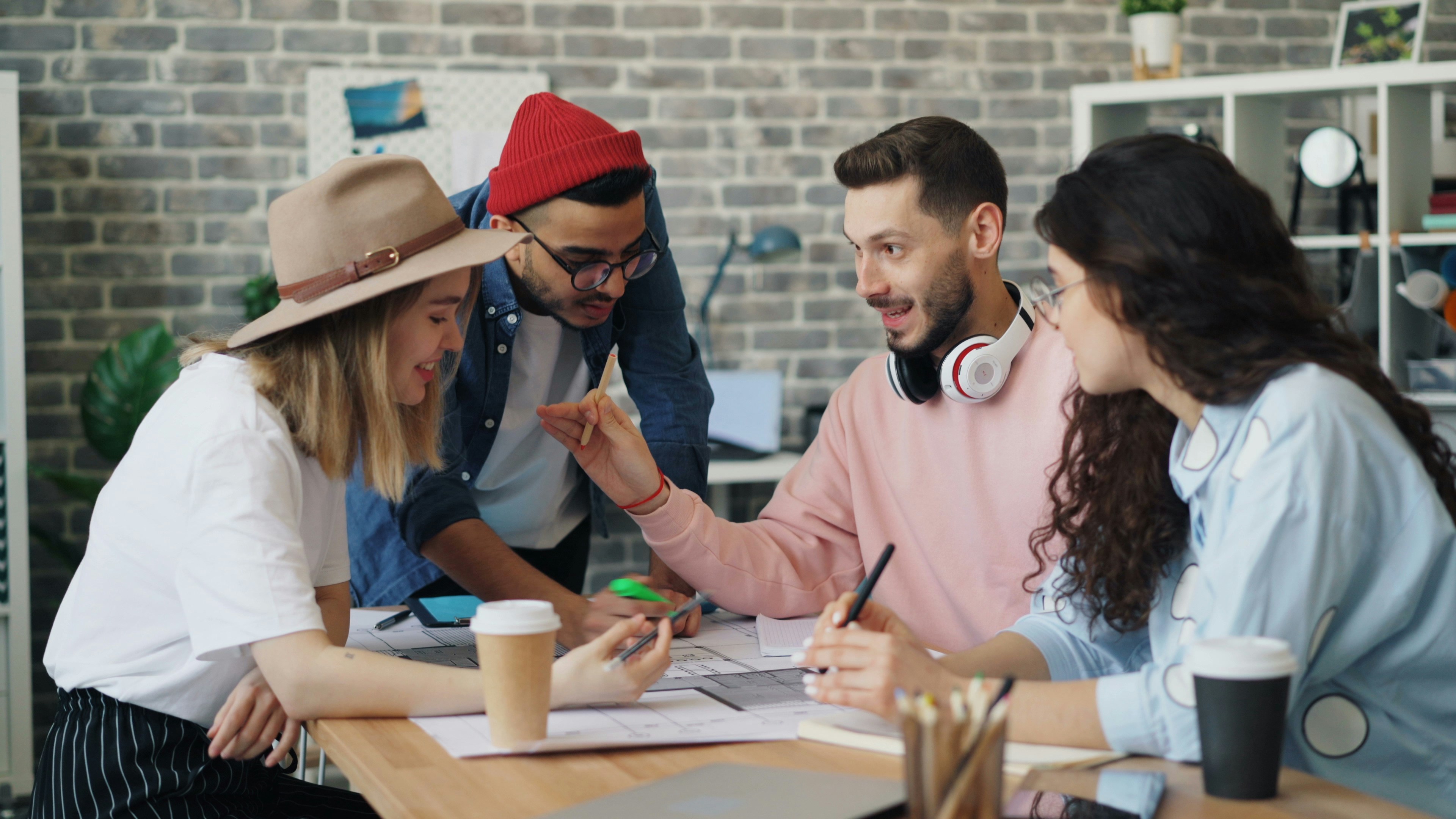 group of people in a community sitting around a table and talking
