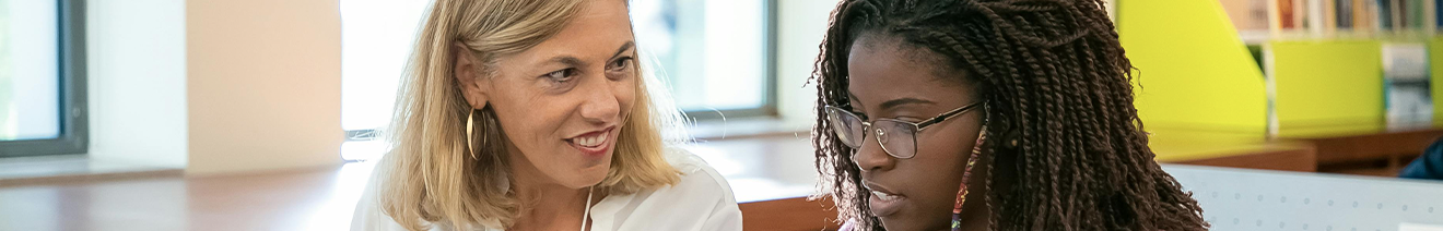 teacher smiling at student during one on one meeting