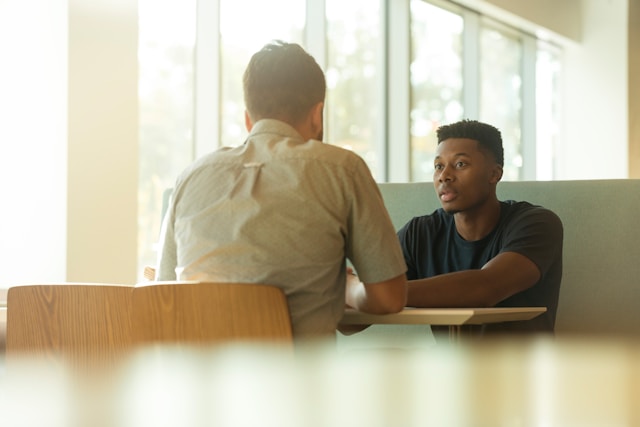 teacher smiling at student during one on one meeting