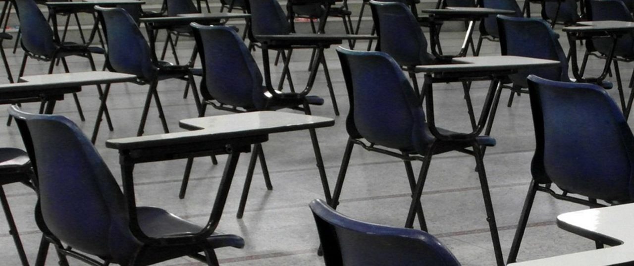 Blue chairs and desks in an empty classroom