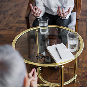 A man seated on a chair, offering guidance to early career faculty at KSU.