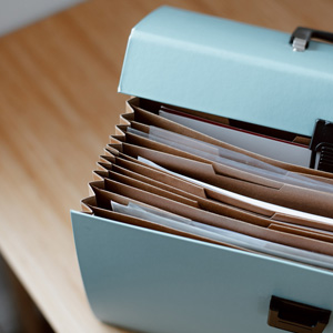 A blue accordiant folder with several folders on top, representing the KSU Human Resources Employee Toolkit.