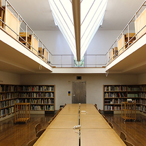 A spacious table with multiple chairs, intended for group learning and teaching resources activities