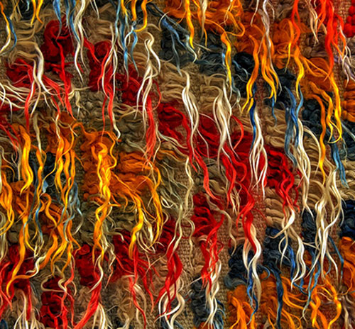 Close-up image of a richly colored rug, highlighting its diverse patterns and vivid colors.