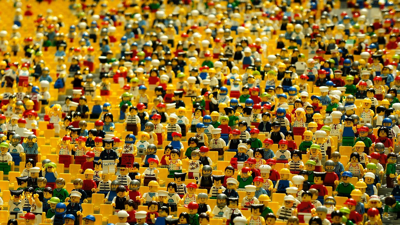 A collection of LEGO figures stands together in a room, illustrating a dynamic and imaginative environment.