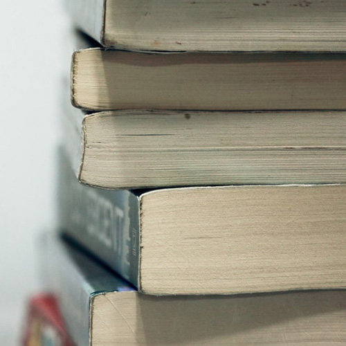 Large thick books stacked on top of each other