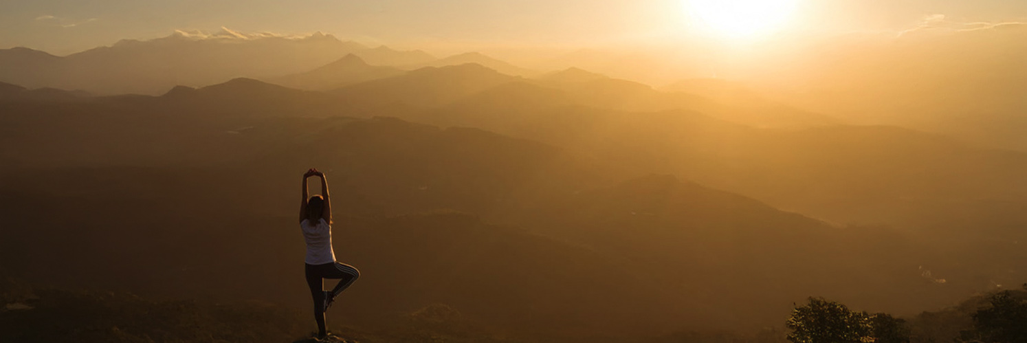 women stretching on mountain with view