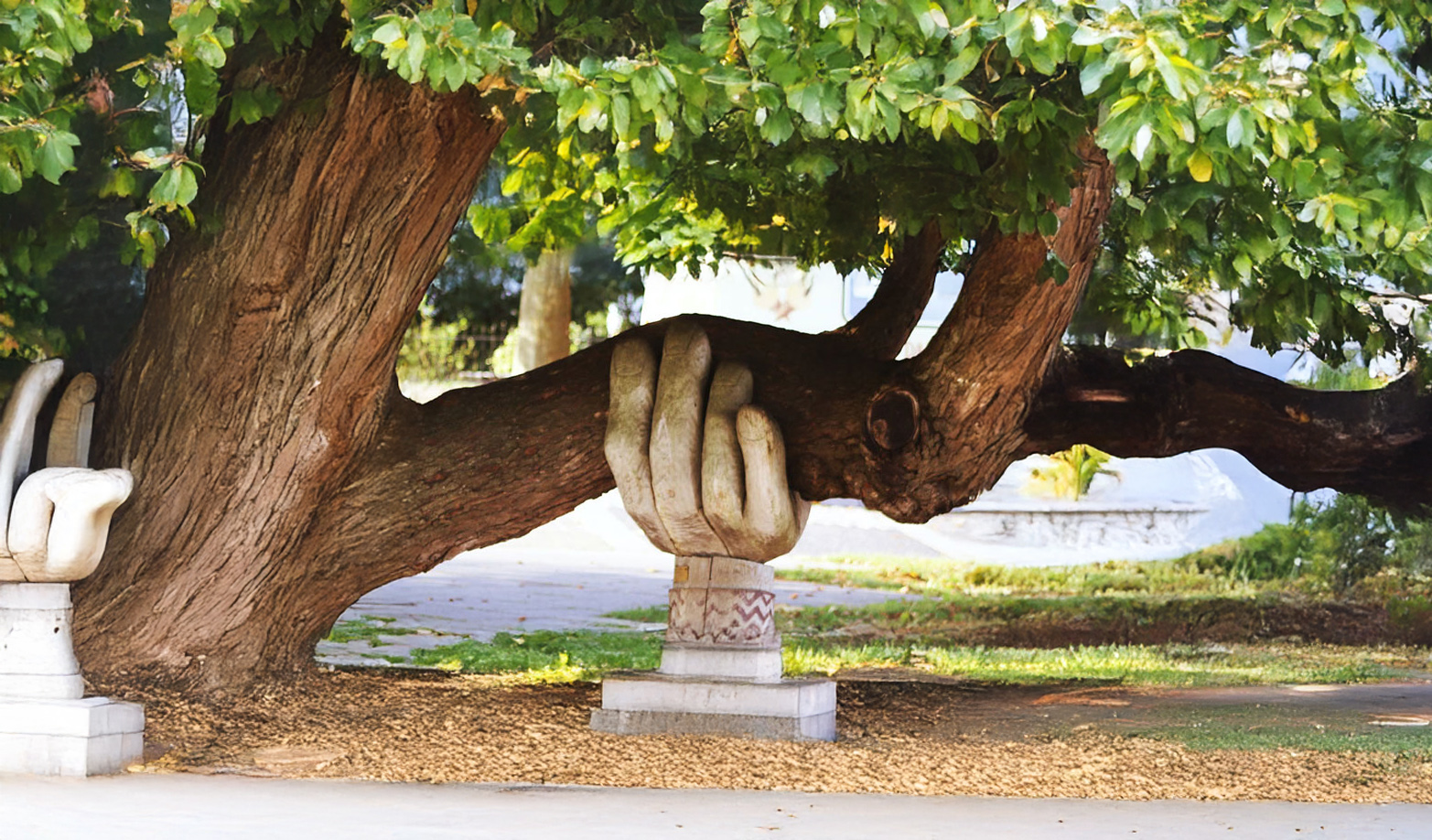 hand statue under tree