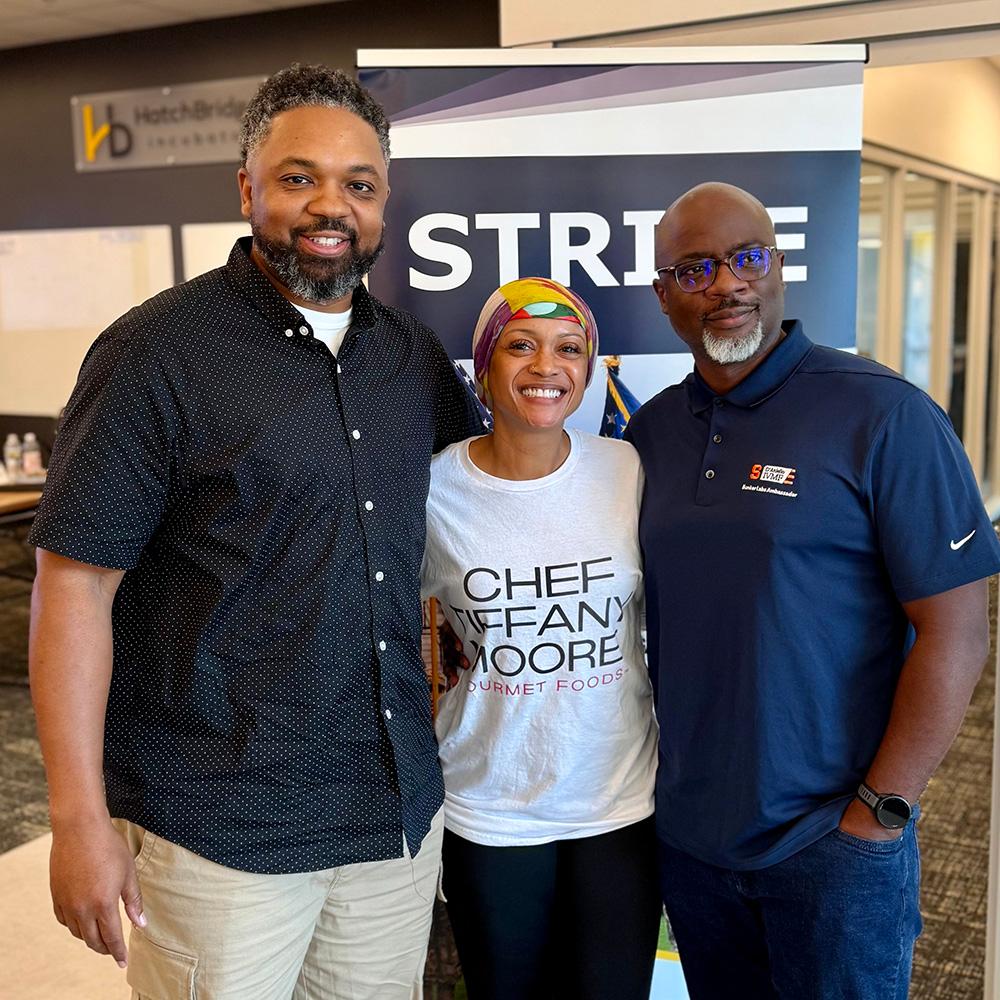 Three STRIVE students stand with each other / 