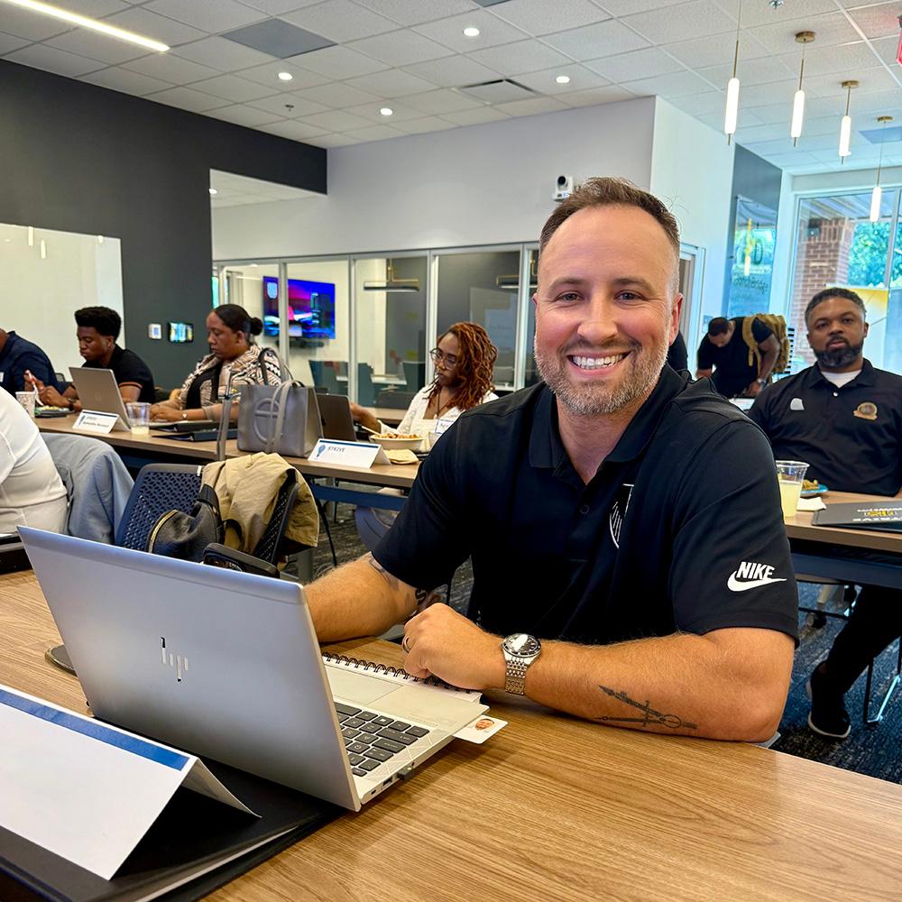 a student sits at the front of a classroom / 