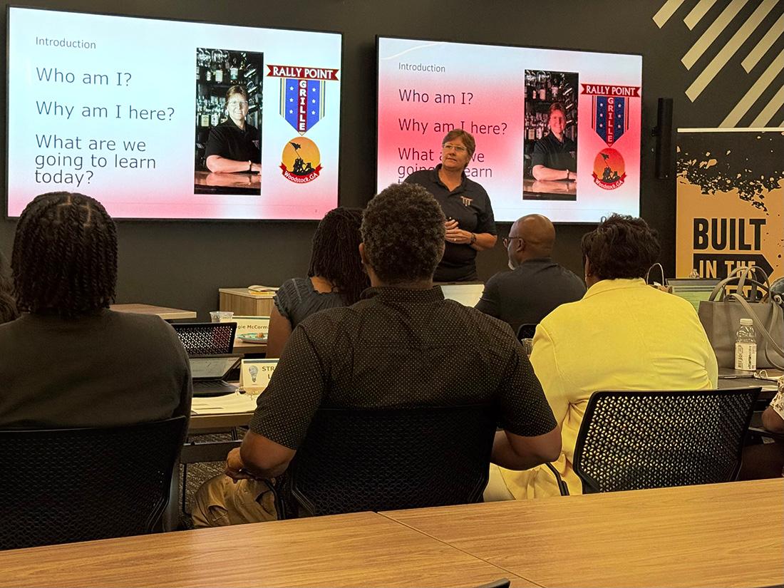 a STRIVE instructor gives a lecture to class room / 