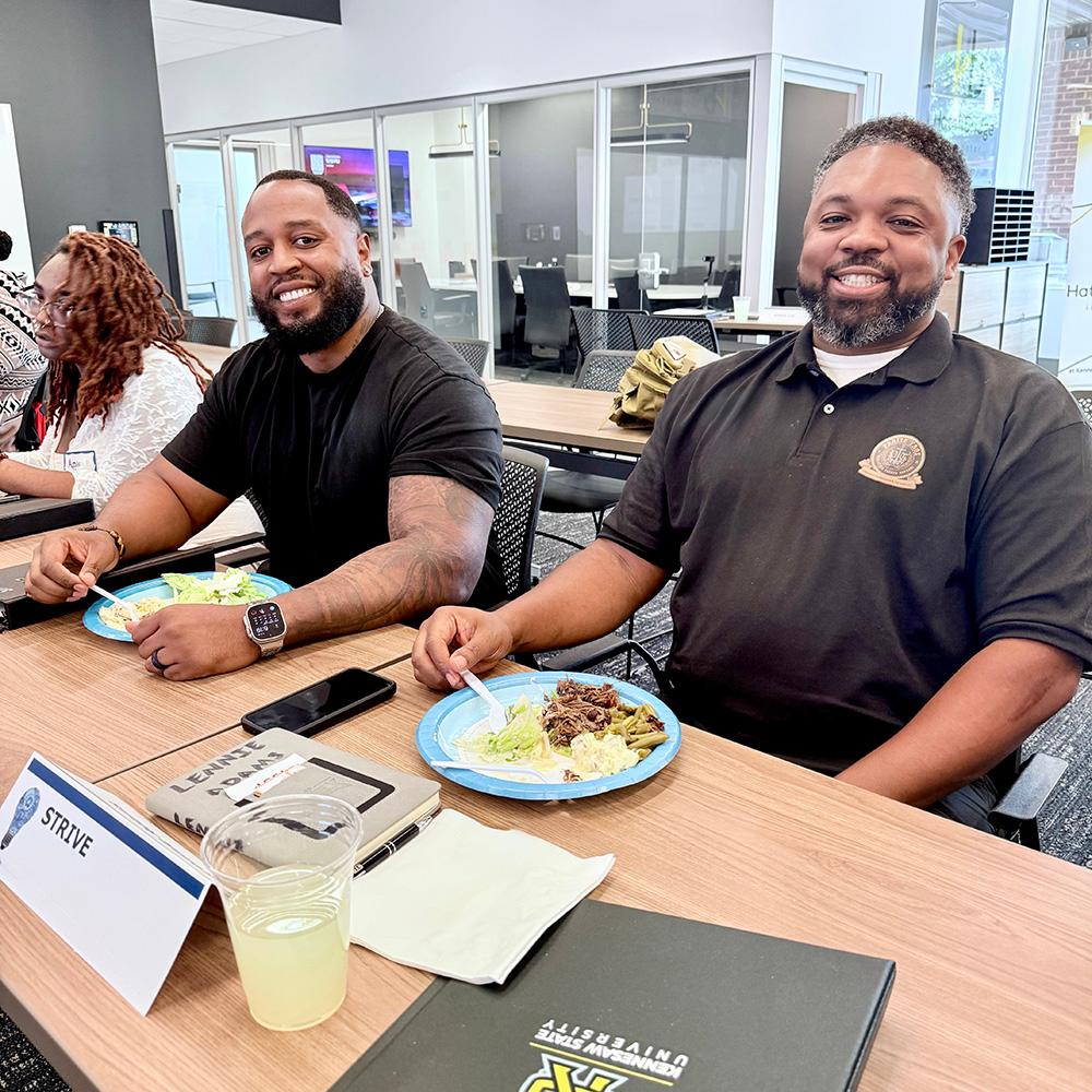 two STRIVE students eating lunch during class / 