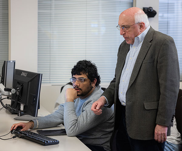 ksu student with their mentor looking at computer screen