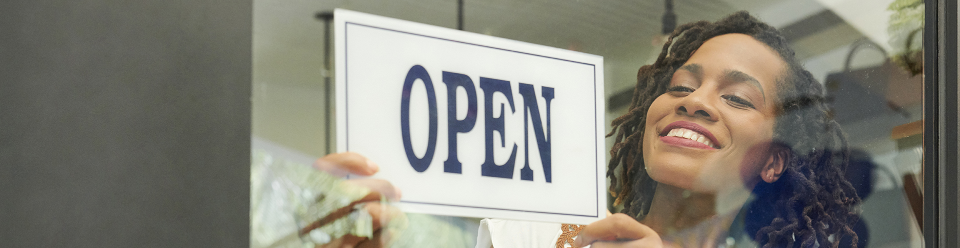 Woman business owner opening her shop for the morning