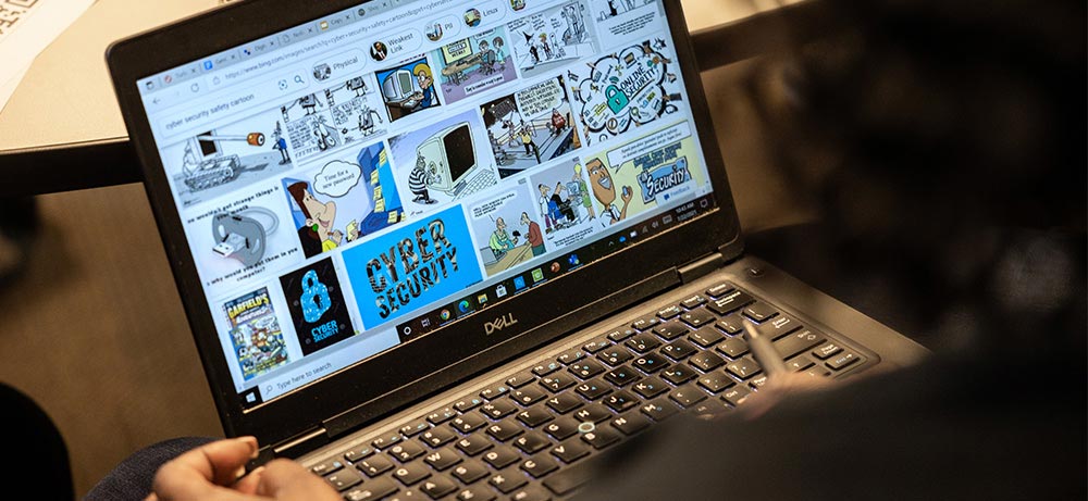 ksu student googling cyber security safety cartoon and looking at images