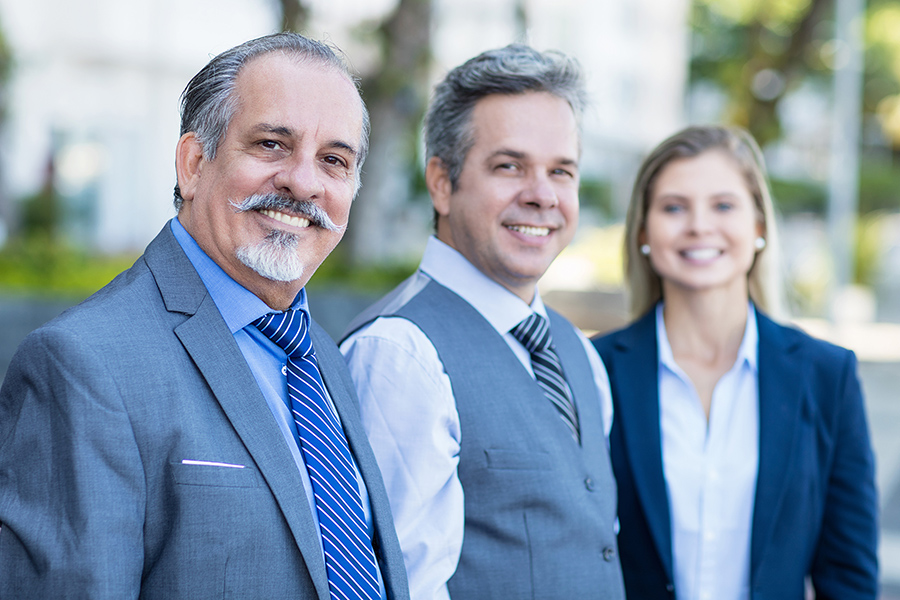 a group of three people dressed in business attire