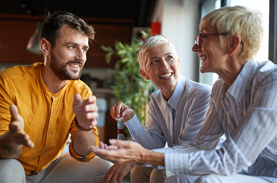 group photo of three people talking