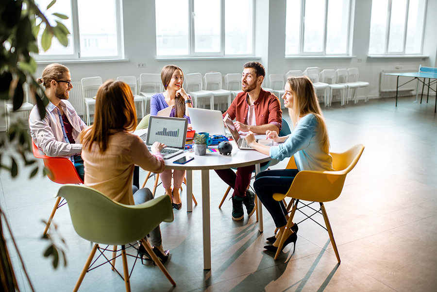 a group of people working together at a table.