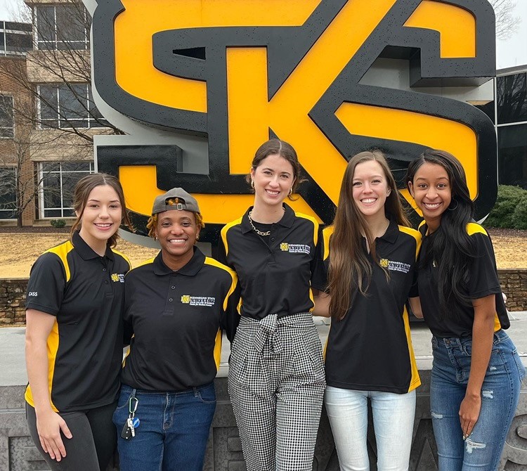 students outside standing in front of the ksu sign