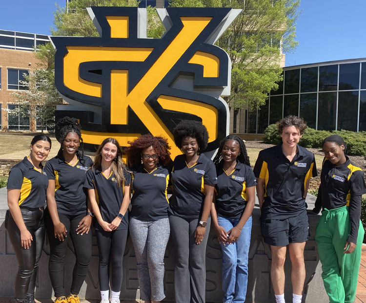 students outside standing in front of the ksu sign