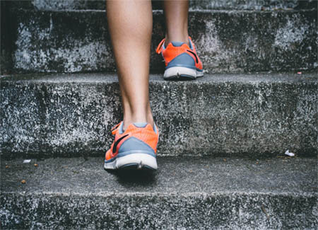 photo of feet walking up stairs