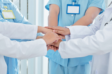 photo of doctors joining hands