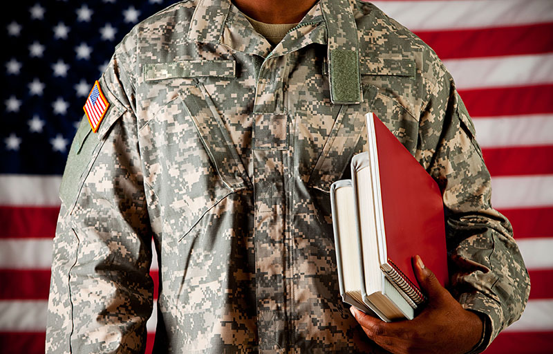 military student in front of flag