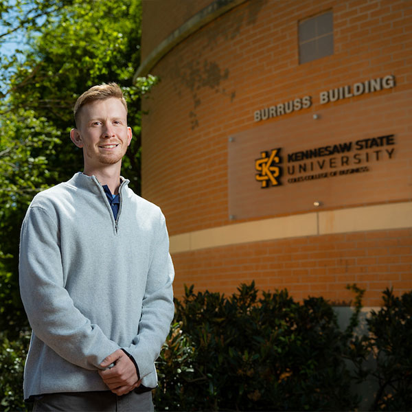 KSU Finance student standing infront of the Coles Burruss building.