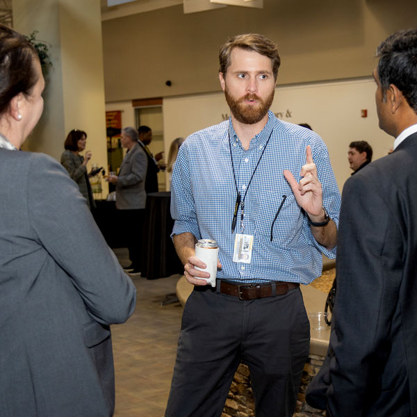 coles marketing and sales students in conversation at conference