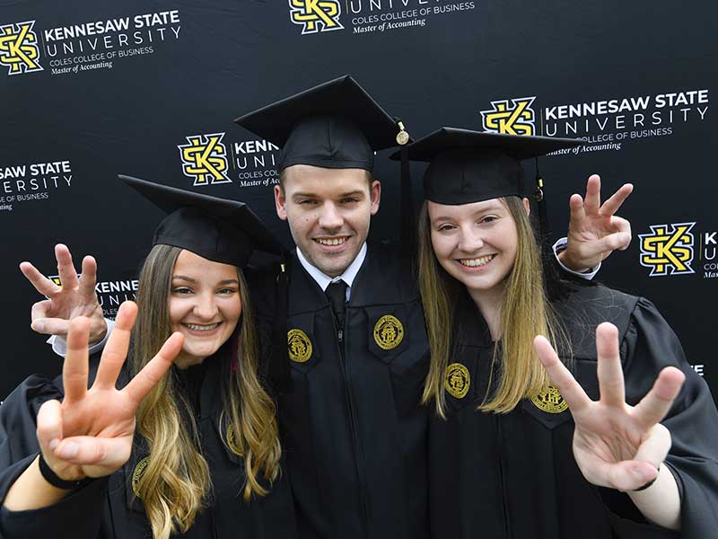 coles master of accounting students posing together during graduation ceremony 