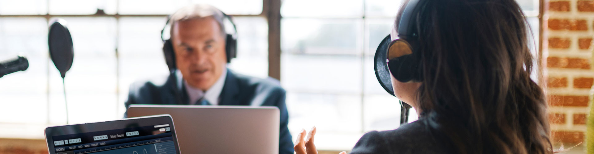 photo of two people recording podcast