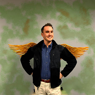 coles master of accounting student posing with owl  wings in background