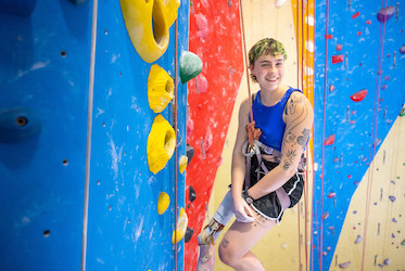 Mary Tankersley seen climbing a rock wall