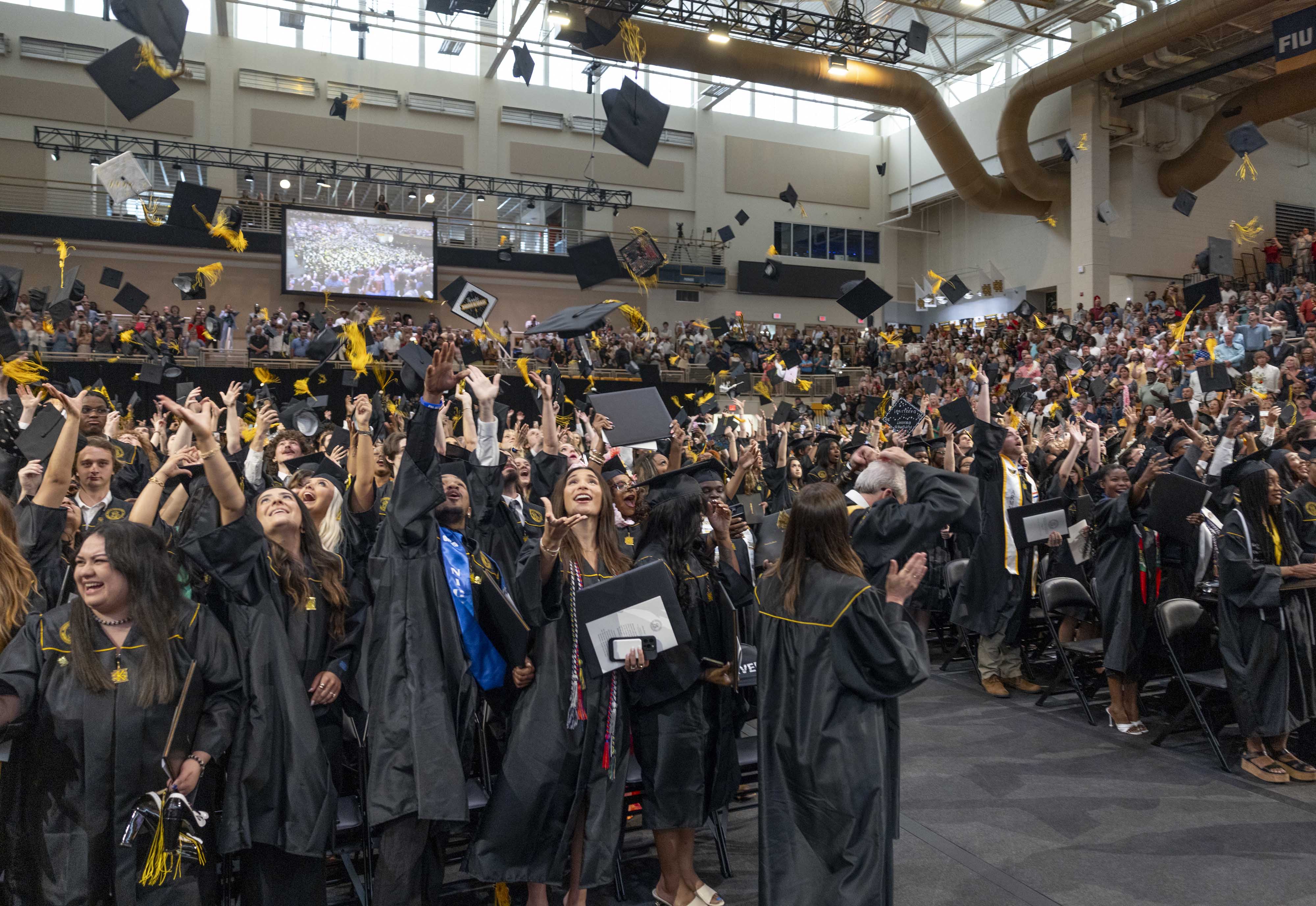 KSU students excited about graduation and throwing caps in the air