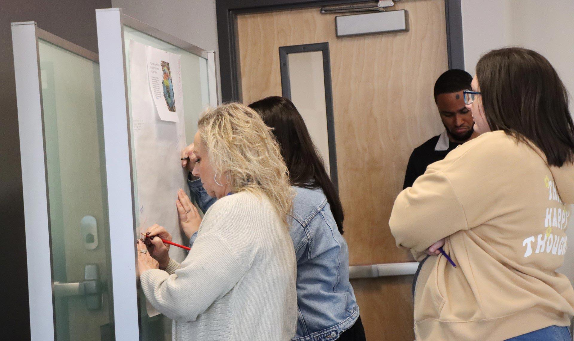  / Group of people collaborating at the ESOL Conference.