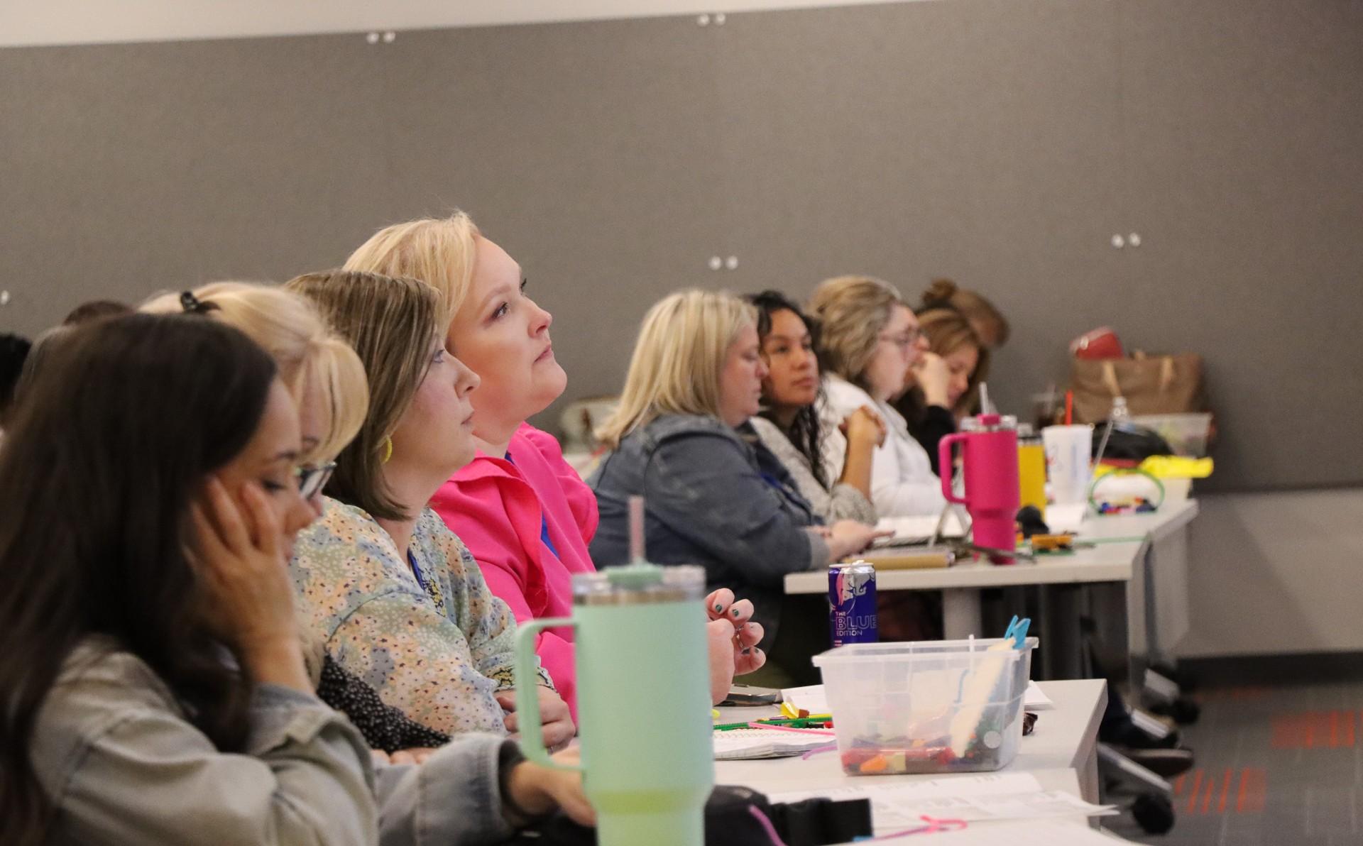  / A large group of people participating in the ESOL Conference.